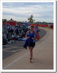 Trotting over to transition area for the next round... 56 miles on her bike.